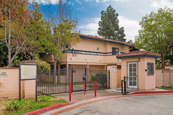 Front view of a two-story building with a gated entrance.