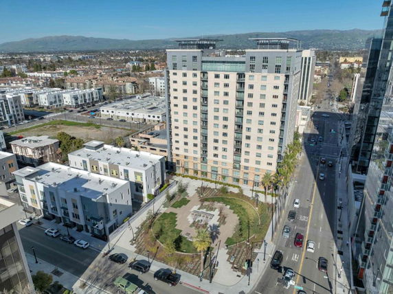 High-rise building with surrounding residential area viewed from above.