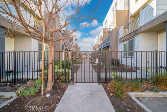 Front view of a modern apartment complex with gated entry.