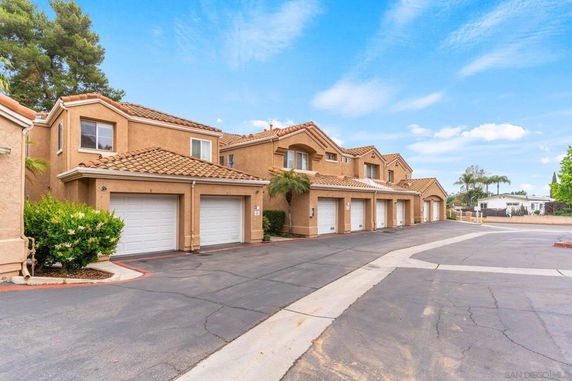 Front view of a multi-unit residential building with garages.