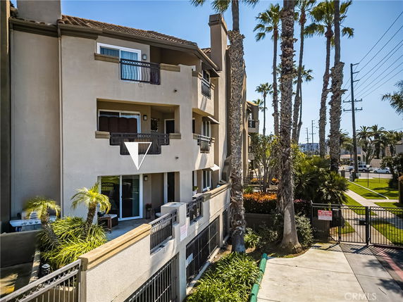 Front view of a multi-story residential building with balconies.