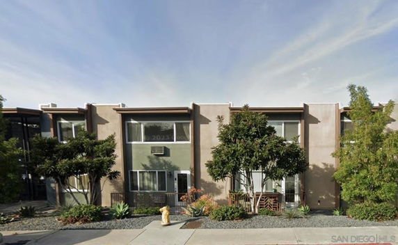 Front view of a modern two-story building with large windows and a minimalistic design.