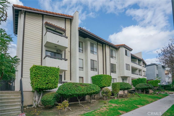Front view of a multi-story residential building with balconies.