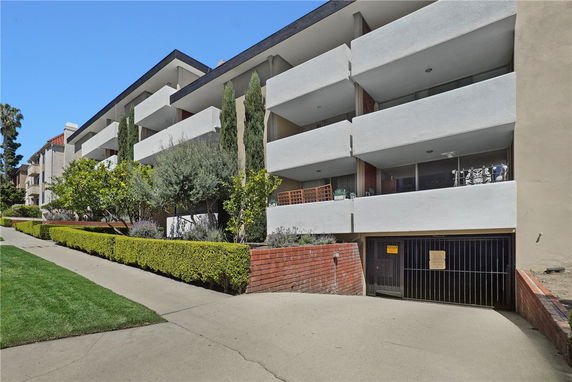Front view of a multi-story residential building with balconies.
