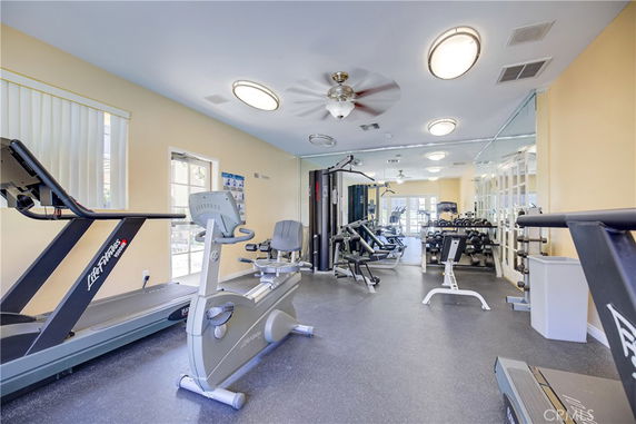 Indoor gym with various exercise equipment, including treadmills and weights.
