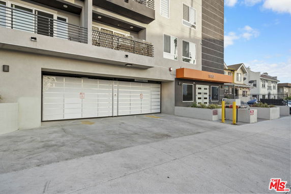 Front view of a multi-story building with a garage entrance.