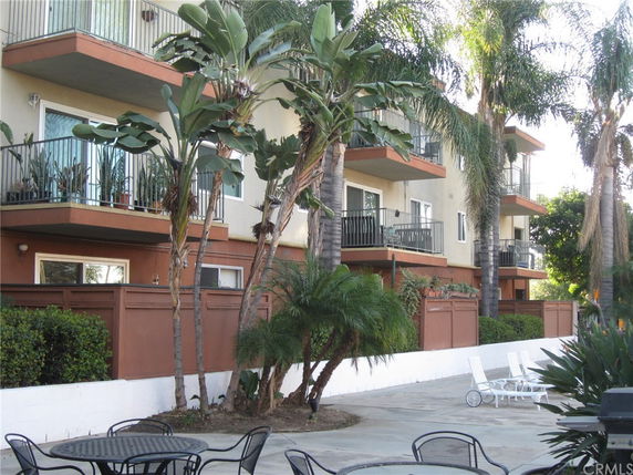Elevated view of a multi-story apartment building with balconies.
