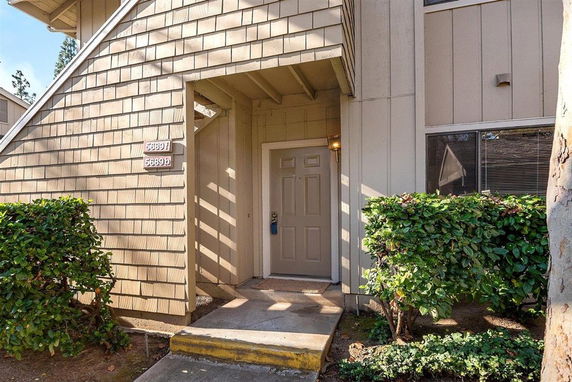 Front view of a building entrance with a door and stairs.