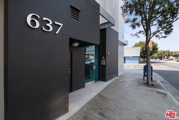 Front view of a commercial building entrance with large street number 637.