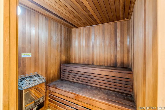 Interior view of a wooden sauna room with benches.