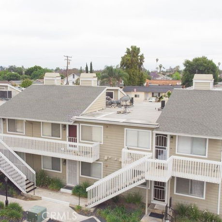 Front view of a two-story apartment building with exterior staircases.