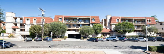 Front view of a multi-story apartment building with balconies.