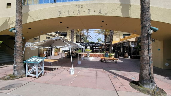 Front view of a commercial plaza entrance with archway.