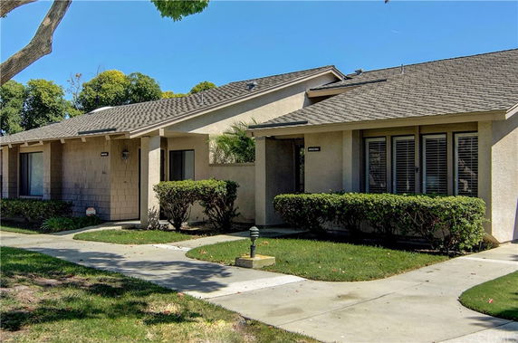 Front view of a single-story house with a sloped roof and attached porch.