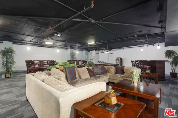 Spacious indoor area with seating and tables for recreation.