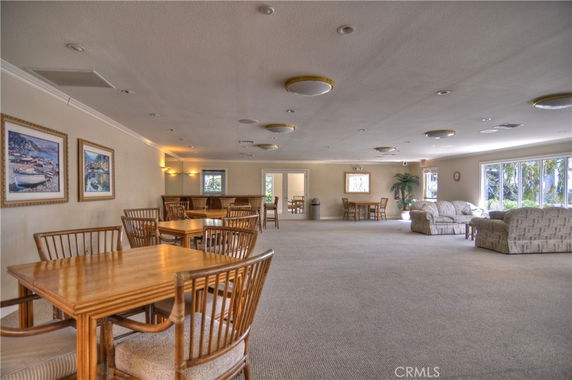 Large indoor common area with tables, chairs, and sofas.
