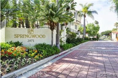 Front view of a residential building with a sign reading 'Springwood 2971'.