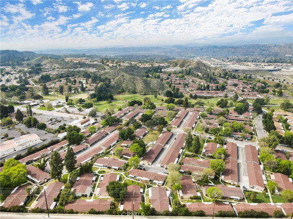 Aerial view showing a neighborhood with multiple rows of residential buildings.