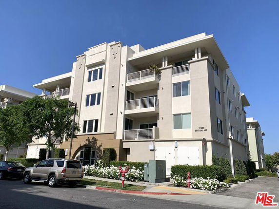 Front view of a multi-story residential building with balconies.