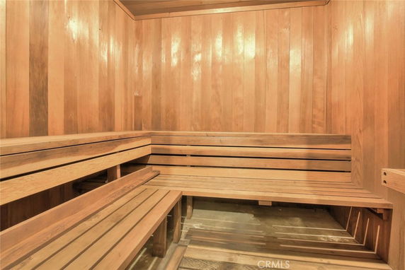 Wooden interior of a sauna room with benches.