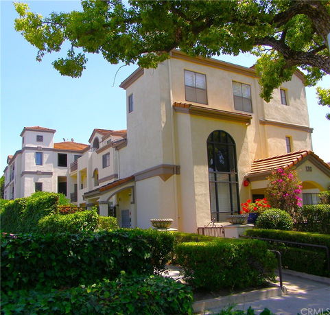 Front view of a multi-story building with a large arched window.