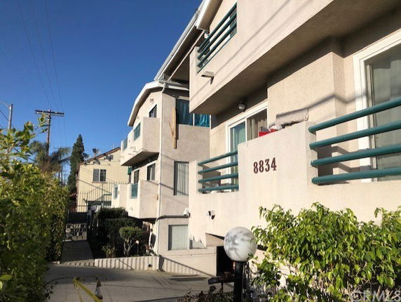 Front view of a multi-story residential building with balconies.