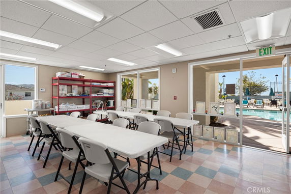 Indoor recreation area with tables and chairs set up for activities.
