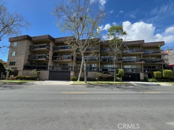 Front view of a multi-story residential building with balconies.