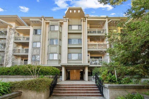 Front view of a multi-story residential building with balconies.