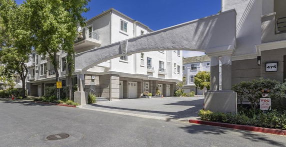 Front view of a multi-story residential building with garages.