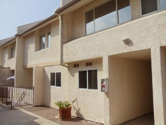 Front view of a two-story building with windows.