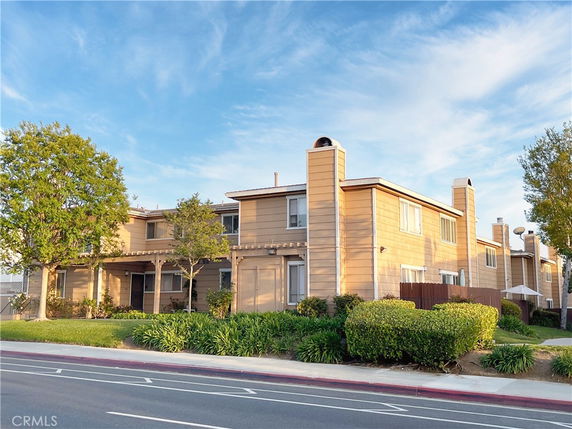 Front view of a two-story building with a modern design and multiple chimneys.