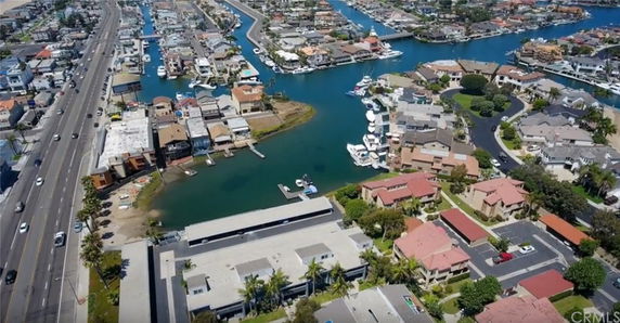 Panoramic view of a coastal residential area with waterways and boats.
