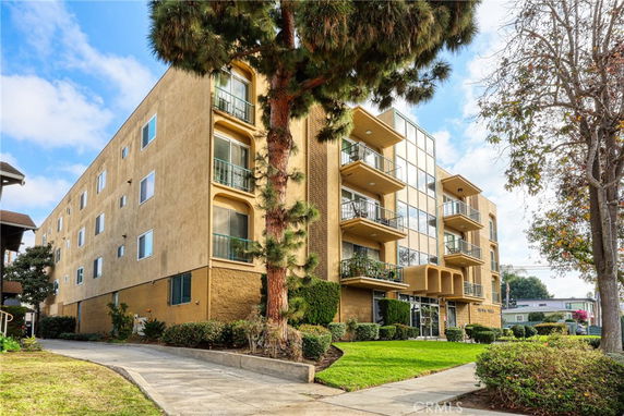 Front view of a multi-story apartment building with balconies.
