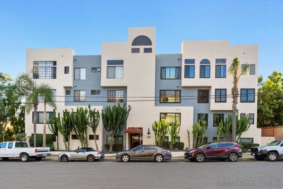 Front view of a multi-story apartment building with modern design elements.