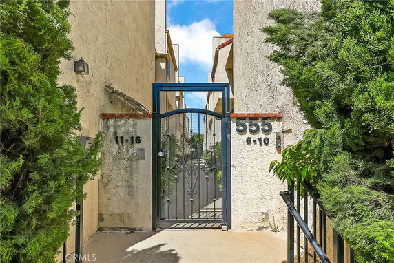 Front view of a gated entrance to a residential building with unit numbers 6-10 and 11-16.