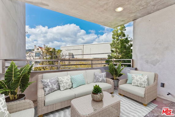 Outdoor sitting area with a view of surrounding buildings.