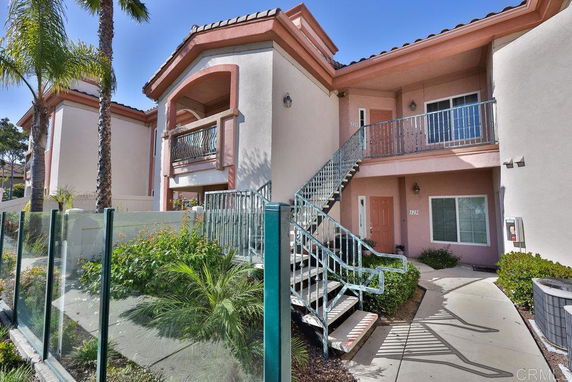 Front view of a two-story building with an external staircase and balconies.