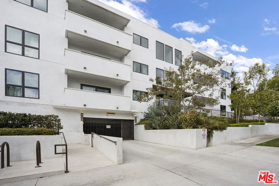 Front view of a multi-story residential building with balconies.