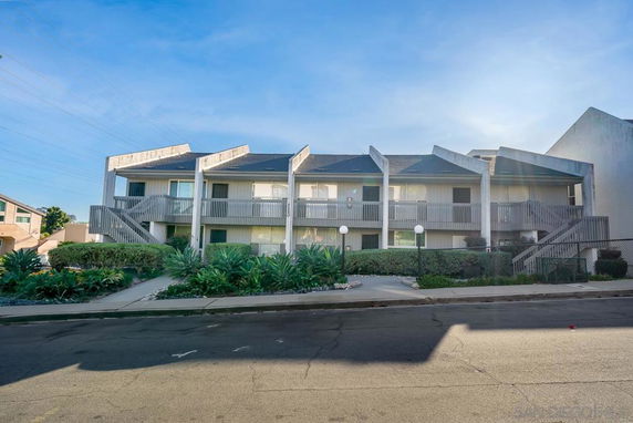 Front view of a two-story residential building with multiple balconies.