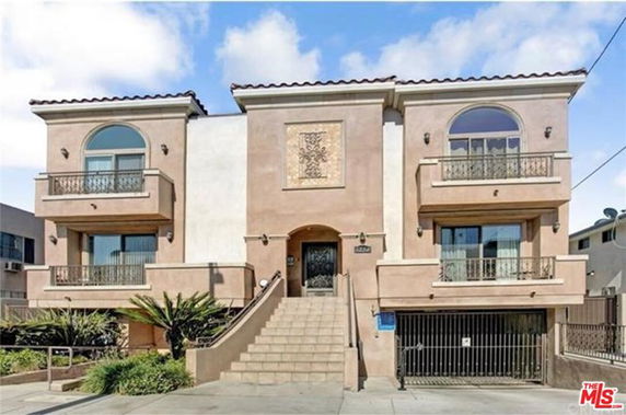 Front view of a multi-story residential building with balconies.