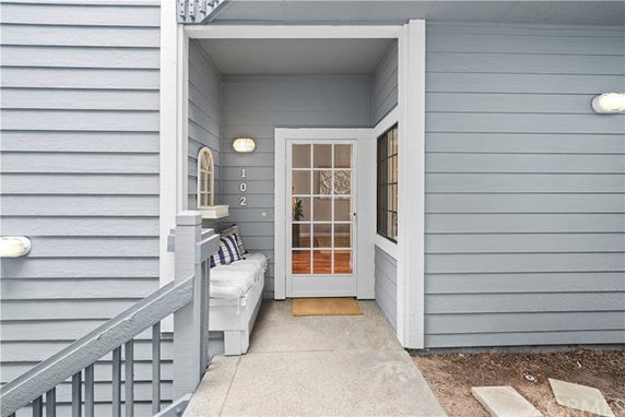 Front view of a house entrance with a glass-panel door and a small porch.