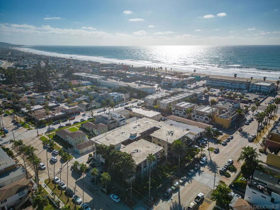 Wide-angle view of a coastal area with buildings and ocean.