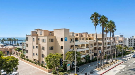 Front view of a multi-story apartment building near the beach.