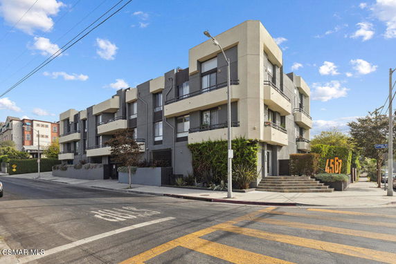 Front view of a modern multi-story building with balconies.