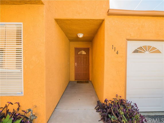Front view of a house with an orange exterior and a small entrance area.