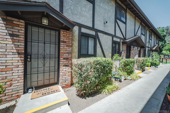 Front view of a multi-unit building with brick and stucco exterior.