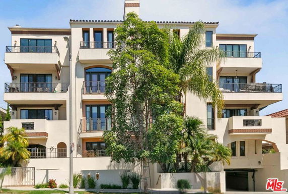 Front view of a multi-story residential building with balconies.