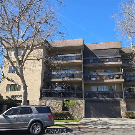 Front view of a multi-story apartment building with balconies.
