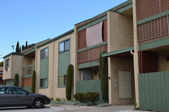 Front view of a multi-story residential building with balconies.
